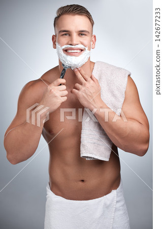Portrait, happy man and shaving in studio for grooming, maintenance and beard cream by backdrop. Male person, body and pride with foam for skincare, hair removal and facial product by grey background 142677233
