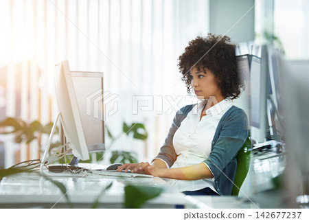 Computer, typing and business woman in office with research online for creative project planning. Technology, reading and professional female designer writing email for review or report in workplace. Computer, typing and business woman in office with research online for creative project planning. Technology, reading and professional female designer writing email for review or report in workplace. 142677237