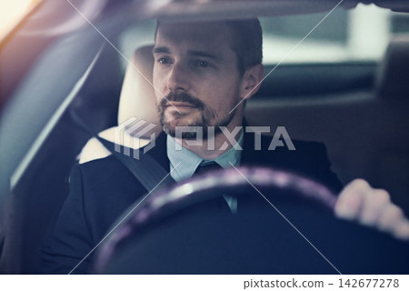 Businessman, thinking and driving in car for travel for commute to corporate work or job as entrepreneur of company. Man, motor vehicle and daily journey with transportation, traffic and on route. Businessman, thinking and driving in car for travel for commute to corporate work or job as entrepreneur of company. Man, motor vehicle and daily journey with transportation, traffic and on route. 142677278