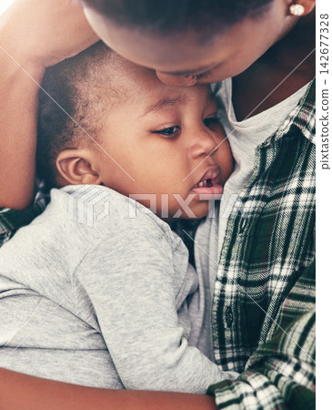 Love, mother and comfort sad baby with forehead kiss for bonding, affection and support for child development. Black people, woman and hugging unhappy kid in home with security, protection and care Love, mother and comfort sad baby with forehead kiss for bonding, affection and support for child development. Black people, woman and hugging unhappy kid in home with security, protection and care 142677328