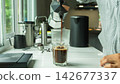 people using Italian classic Moka coffee pot pouring, coffee maker with equipment tool brewing marble bar at home kitchen 142677337