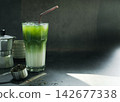 iced Matcha green tea with Italian Moka pot coffee equipment to brew and powdered green tea on a spoon. light, black background. copy space for your text 142677338
