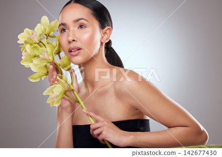 Girl, orchid and plant for skincare in studio, facial treatment and sustainable cosmetics. Female person, leaves and eco friendly product for pamper mockup, organic dermatology and gray background Girl, orchid and plant for skincare in studio, facial treatment and sustainable cosmetics. Female person, leaves and eco friendly product for pamper mockup, organic dermatology and gray background 142677430