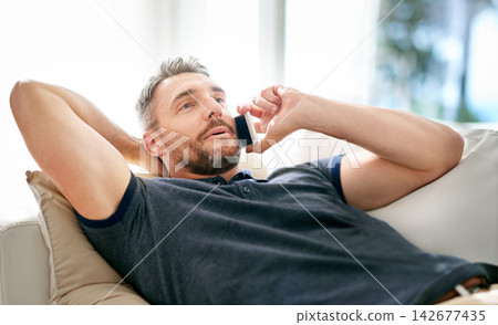 Man, phone call and relax on sofa for conversation, communication and good news in lounge. Person, happy and mobile smartphone for talk, chatting or speaking for discussion and break at home Man, phone call and relax on sofa for conversation, communication and good news in lounge. Person, happy and mobile smartphone for talk, chatting or speaking for discussion and break at home 142677435