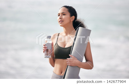Beach, woman and water bottle or mat after yoga for hydration, wellness and health. Female yogini, thirsty and mineral liquid or H2O or fluid for drinking, detox and thinking of fitness exercise Beach, woman and water bottle or mat after yoga for hydration, wellness and health. Female yogini, thirsty and mineral liquid or H2O or fluid for drinking, detox and thinking of fitness exercise 142677904