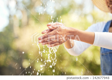 Woman, outdoor and water for washing hands in nature for germs, health care and sanitation for wellness in countryside. Person, farmer and cleaning in environment with h2o for sustainability and eco. Woman, outdoor and water for washing hands in nature for germs, health care and sanitation for wellness in countryside. Person, farmer and cleaning in environment with h2o for sustainability and eco. 142677948