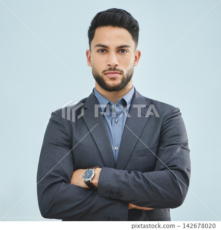 Crossed arms, serious and portrait of businessman in studio with pride, confidence and legal career. Professional, corporate and male attorney from Colombia in suit for law by gray background. Crossed arms, serious and portrait of businessman in studio with pride, confidence and legal career. Professional, corporate and male attorney from Colombia in suit for law by gray background. 142678020
