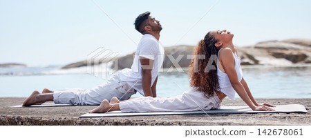 Couple, yoga and beach for wellness on mat, relationship bonding and body health or stretch with exercise. Spiritual, holistic training and trust or outdoor meditation, ocean and mindfulness practice 142678061
