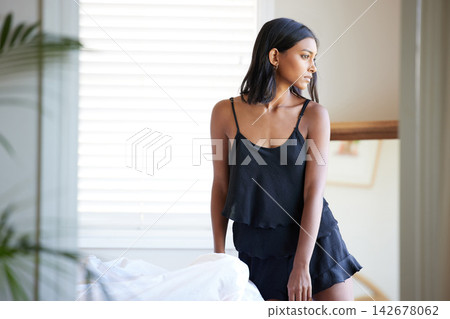 Thinking, morning and woman in apartment with pyjamas for outfit idea, remember and relax for peace in home. Indian gen z girl, weekend and daydream by bed with thoughtful, natural light and wellness Thinking, morning and woman in apartment with pyjamas for outfit idea, remember and relax for peace in home. Indian gen z girl, weekend and daydream by bed with thoughtful, natural light and wellness 142678062