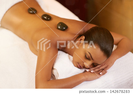 Spa, hot stone and woman with massage, relax and calm with stress relief, skincare and vacation. Person, holiday and girl with health, treatment and wellness with zen therapy masseuse and body luxury Spa, hot stone and woman with massage, relax and calm with stress relief, skincare and vacation. Person, holiday and girl with health, treatment and wellness with zen therapy masseuse and body luxury 142678283
