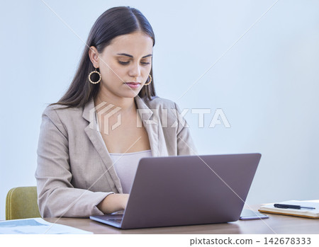 Laptop, typing and business woman reading email for project, research or communication online in office. Computer, serious and professional on website for planning, networking or agent writing report Laptop, typing and business woman reading email for project, research or communication online in office. Computer, serious and professional on website for planning, networking or agent writing report 142678333