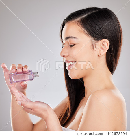 Happy, woman and haircare with keratin serum, growth and product placement isolated in studio. Female person or promotion and cosmetics for healthy hair benefits for advertising and wellness 142678394