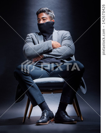 Gangster, criminal and man with fashion in chair on studio, dark background or thinking of power. Serious, person and cool style with mask on face with mob secret, danger or character in mafia crime Gangster, criminal and man with fashion in chair on studio, dark background or thinking of power. Serious, person and cool style with mask on face with mob secret, danger or character in mafia crime 142678426