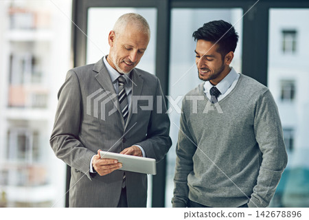Mature, man and young male for mentor, tablet and pointing in office for advice in business or workplace. Employee, intern and technology in meeting for brainstorming, ideas and plan in corporate Mature, man and young male for mentor, tablet and pointing in office for advice in business or workplace. Employee, intern and technology in meeting for brainstorming, ideas and plan in corporate 142678896