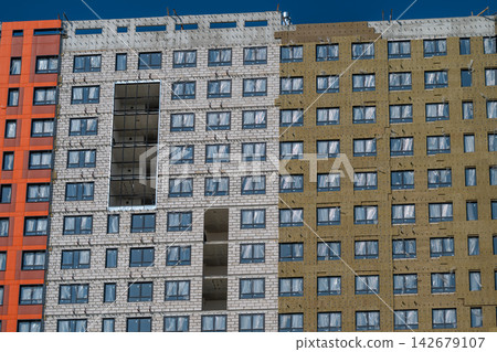 Modern architectural design showcasing a colorful facade with distinct textures and windows in bright sunlight capturing urban beauty and creativity Modern architectural design showcasing a colorful facade with distinct textures and windows in bright sunlight capturing urban beauty and creativity 142679107