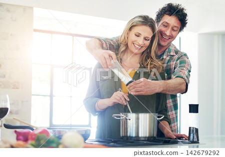 Mature, couple and support or cooking in kitchen with spices, meal prep and dinner in home with helping. People, happy and bonding in apartment with healthy recipe and food for nutrition and flavor Mature, couple and support or cooking in kitchen with spices, meal prep and dinner in home with helping. People, happy and bonding in apartment with healthy recipe and food for nutrition and flavor 142679292