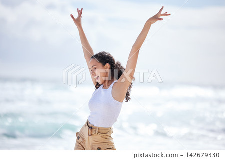 Woman, excited and dancing on beach with freedom for adventure, celebration and summer vacation on mockup. Person, happy and carefree with energy for holiday fun, enjoyment and entertainment by ocean 142679330