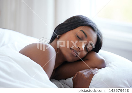 Indian woman, sleeping and rest in bed in natural light with white duvet, peaceful and dreaming in bedroom. Calm, relaxed and female person with comfort at home at sunrise with tired, weekend and nap Indian woman, sleeping and rest in bed in natural light with white duvet, peaceful and dreaming in bedroom. Calm, relaxed and female person with comfort at home at sunrise with tired, weekend and nap 142679438