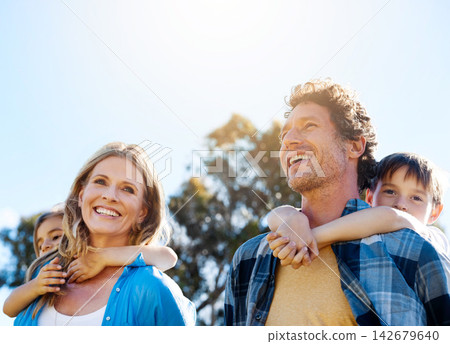 Family, smile and piggyback in nature with love for bonding, weekend fun and sunshine in park with sky. Parents, kids and carry on back for summer activity, outdoor scenery and happy on morning walk Family, smile and piggyback in nature with love for bonding, weekend fun and sunshine in park with sky. Parents, kids and carry on back for summer activity, outdoor scenery and happy on morning walk 142679640