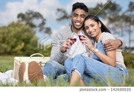 Couple, toast and picnic in portrait with wine, basket and hug on grass for anniversary. Happy man, woman and together with drink in field for love, commitment and celebration in relationship Couple, toast and picnic in portrait with wine, basket and hug on grass for anniversary. Happy man, woman and together with drink in field for love, commitment and celebration in relationship 142680020