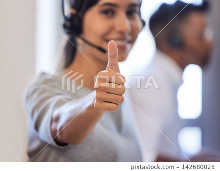 Call center, agent and woman with thumbs up in office, happy and customer service and support with employee. Telemarketing, company and mission or contact us with consultant, good job and gesture Call center, agent and woman with thumbs up in office, happy and customer service and support with employee. Telemarketing, company and mission or contact us with consultant, good job and gesture 142680023