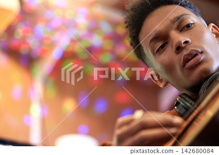 Music, art and man with guitar at a club for concert, performance and jazz, night and event. Acoustic, stage or live band member with instrument at disco for creative, skills or rock star festival Music, art and man with guitar at a club for concert, performance and jazz, night and event. Acoustic, stage or live band member with instrument at disco for creative, skills or rock star festival 142680084