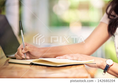 Hands, writing and person with notebook for inventory, stocktake or order products in office. Small business, entrepreneur and florist with pen at nursery for planning, checklist or price list 142680204