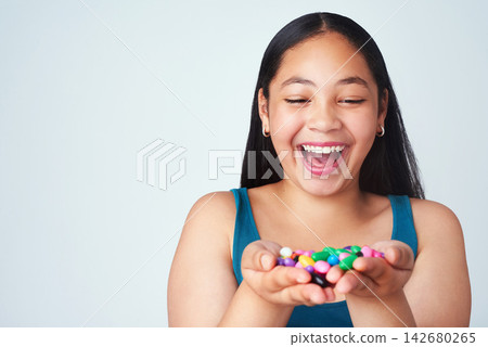 Child, candy or smile at wow, winner and success, white background or gratitude at dream. Excited, girl or hand with jelly beans to omg, thinking or treasure of reward at achievement in mockup studio Child, candy or smile at wow, winner and success, white background or gratitude at dream. Excited, girl or hand with jelly beans to omg, thinking or treasure of reward at achievement in mockup studio 142680265