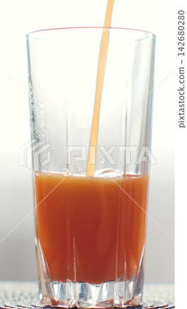 Vertical video. Pouring orange juice from glass jar into glass. Healthy nutrition, organic drink and fasting cleanse concept. 142680280