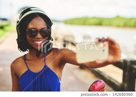 Selfie, black woman and scooter outside with smile for fun in summer on vacation in outdoors. Joy, sunglasses and travel with happy in nature with tourist in France for social media or memories. Selfie, black woman and scooter outside with smile for fun in summer on vacation in outdoors. Joy, sunglasses and travel with happy in nature with tourist in France for social media or memories. 142680360