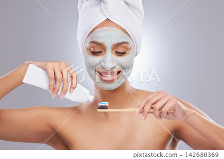 Woman, face mask and toothbrush for hygiene, cosmetics and skincare on white background. Facial, dental and toothpaste with product for female person, studio and towel for grooming and dermatology Woman, face mask and toothbrush for hygiene, cosmetics and skincare on white background. Facial, dental and toothpaste with product for female person, studio and towel for grooming and dermatology 142680369