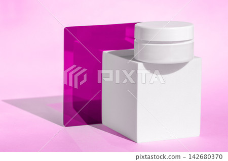 Cosmetic jar cream container with white block and pink background Cosmetic jar cream container with white block and pink background 142680370