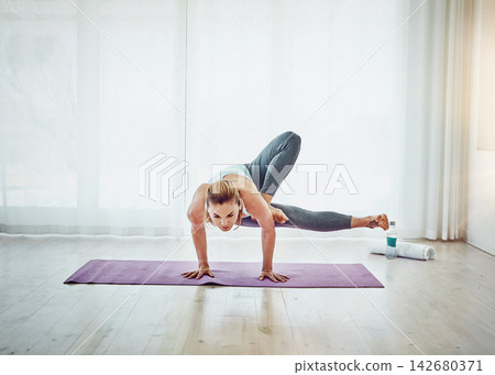 Practice, girl and dragonfly exercise with yoga for strength, arms and legs balance at home. Female yogini, fitness and training as daily routine for wellness, healthy body and flexible endurance Practice, girl and dragonfly exercise with yoga for strength, arms and legs balance at home. Female yogini, fitness and training as daily routine for wellness, healthy body and flexible endurance 142680371
