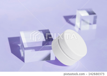 Cosmetic cream container with glass cubes on purple background Cosmetic cream container with glass cubes on purple background 142680373