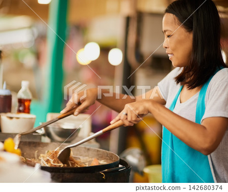 Woman, takeaway market and cooking with Thai dish, vendor of prepare meal with utensils, ingredients or informal business. Traditional, street chef or entrepreneur with culture, food or fried cuisine Woman, takeaway market and cooking with Thai dish, vendor of prepare meal with utensils, ingredients or informal business. Traditional, street chef or entrepreneur with culture, food or fried cuisine 142680374