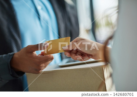 Credit card, delivery man and hands of woman with tablet, package and online shopping service at door. Ecommerce, courier and customer with cardboard box for distribution, easy payment or POS at home Credit card, delivery man and hands of woman with tablet, package and online shopping service at door. Ecommerce, courier and customer with cardboard box for distribution, easy payment or POS at home 142680701