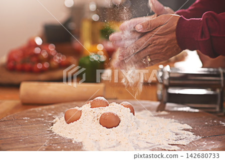 Hands with flour, dough and eggs for baking in kitchen on table for dish, dessert and cookies. Food, cooking and person with wheat ingredients for homemade pasta, cake and bread for culinary cuisine Hands with flour, dough and eggs for baking in kitchen on table for dish, dessert and cookies. Food, cooking and person with wheat ingredients for homemade pasta, cake and bread for culinary cuisine 142680733