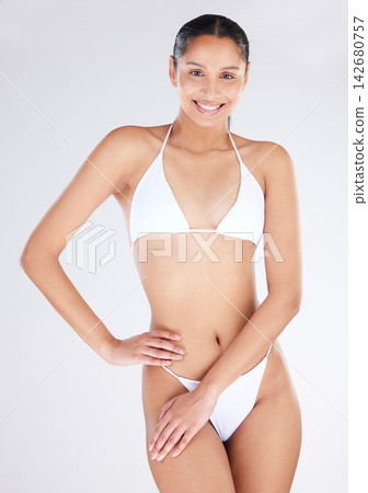 Woman, portrait and confidence in studio with bikini for summer, tropical and beach body. Female model, happy and smile in swimsuit for vacation or holiday on white background with mockup space Woman, portrait and confidence in studio with bikini for summer, tropical and beach body. Female model, happy and smile in swimsuit for vacation or holiday on white background with mockup space 142680757