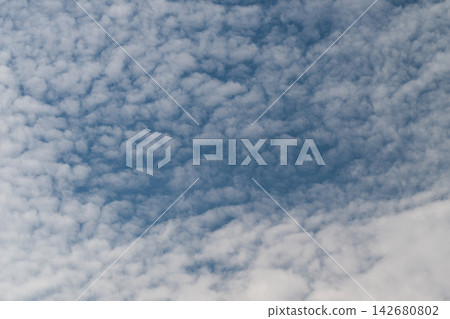 Vast blue sky adorned with fluffy white clouds creates a serene atmosphere amid the gentle warmth of a sunny day Vast blue sky adorned with fluffy white clouds creates a serene atmosphere amid the gentle warmth of a sunny day 142680802