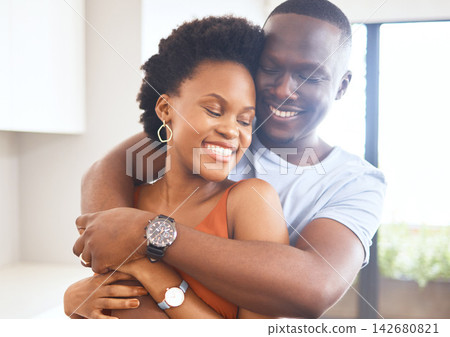 African couple, happy and hug for bonding at home for celebration of new apartment for real estate investment. Smile, married people and support with love embrace for commitment and opportunity African couple, happy and hug for bonding at home for celebration of new apartment for real estate investment. Smile, married people and support with love embrace for commitment and opportunity 142680821