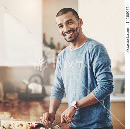 Cooking, meal and man with knife for vegetables, food and dinner in home. Vegan, diet and healthy eating with portrait and recipe for nutrition, smile and male person in kitchen with ingredients Cooking, meal and man with knife for vegetables, food and dinner in home. Vegan, diet and healthy eating with portrait and recipe for nutrition, smile and male person in kitchen with ingredients 142680834
