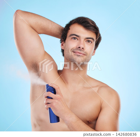 Grooming, man and deodorant in morning, routine and wellness in body care, hygiene and blue background. Male person, cosmetics and fresh for confidence, masculine and fragrance with product in studio Grooming, man and deodorant in morning, routine and wellness in body care, hygiene and blue background. Male person, cosmetics and fresh for confidence, masculine and fragrance with product in studio 142680836