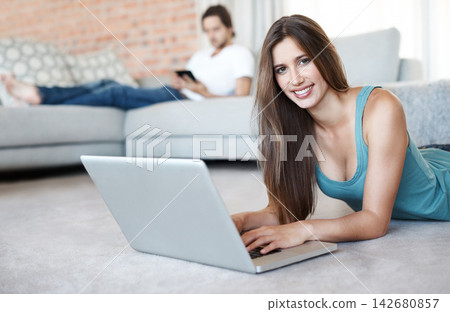 Portrait, happy and woman on floor with laptop at home or living room to relax by streaming internet for entertainment. Smile, female person and digital technology for reading blog on website Portrait, happy and woman on floor with laptop at home or living room to relax by streaming internet for entertainment. Smile, female person and digital technology for reading blog on website 142680857