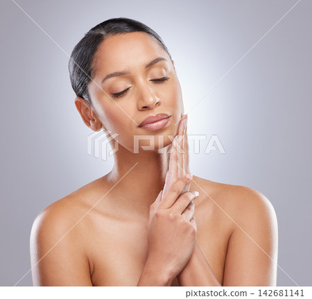 Eyes closed, dermatology and woman with skincare in studio for natural beauty, self care and shine. Person, satisfaction and spa treatment with pride for cosmetics, routine or glow on gray background Eyes closed, dermatology and woman with skincare in studio for natural beauty, self care and shine. Person, satisfaction and spa treatment with pride for cosmetics, routine or glow on gray background 142681141