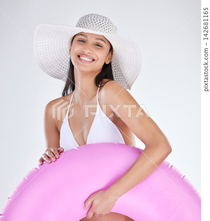 Portrait, smile and woman with bikini, hat and toy for beach fun on white studio background. Face, person and model with happiness, cheerful and girl with vacation, holiday and joy with weekend break Portrait, smile and woman with bikini, hat and toy for beach fun on white studio background. Face, person and model with happiness, cheerful and girl with vacation, holiday and joy with weekend break 142681165