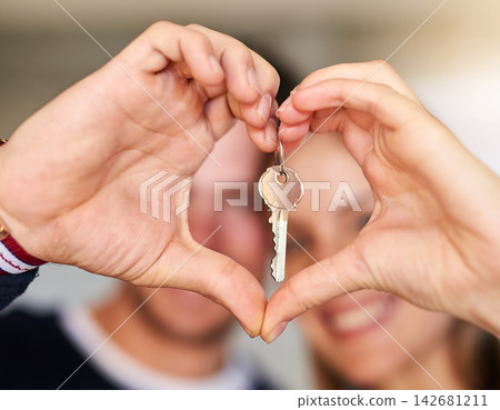 Portrait, couple and keys for new home, heart hands and real estate with love, support and trust. Closeup, man and woman with care emoji, lock for security and symbol for kindness, house and mortgage Portrait, couple and keys for new home, heart hands and real estate with love, support and trust. Closeup, man and woman with care emoji, lock for security and symbol for kindness, house and mortgage 142681211