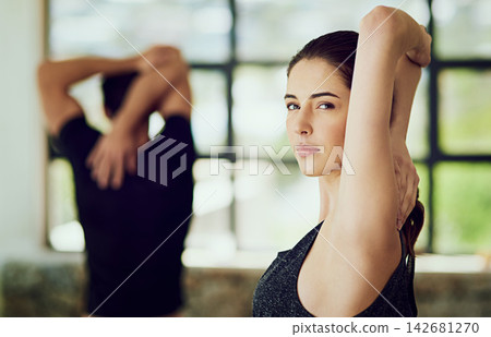 Gym, stretching arms and woman in portrait for fitness, commitment and warm up before exercise. Female athlete, workout partner and training for health, wellness and flexibility in sports indoor Gym, stretching arms and woman in portrait for fitness, commitment and warm up before exercise. Female athlete, workout partner and training for health, wellness and flexibility in sports indoor 142681270
