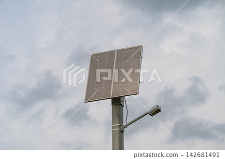 Bright solar panel harnessing energy under a cloudy sky for sustainable power solutions Bright solar panel harnessing energy under a cloudy sky for sustainable power solutions 142681491