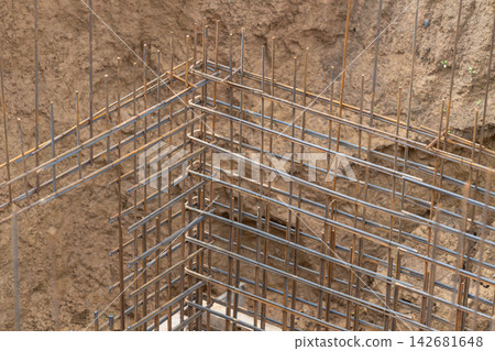 Steel framework rises from the earth at a construction site as workers prepare for a new building project Steel framework rises from the earth at a construction site as workers prepare for a new building project 142681648