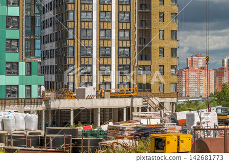 Construction site bustling with activity in a city under a bright sky Construction site bustling with activity in a city under a bright sky 142681773